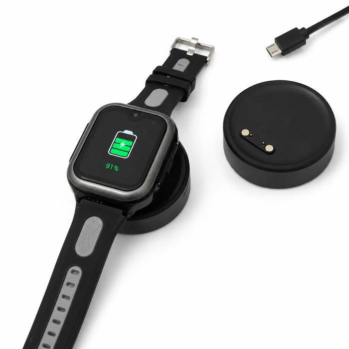 Lil Tracker GPS watch charging on portable magnetic charging dock